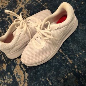 Women’s white Nike sneakers